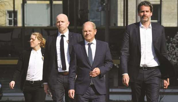 German Finance Minister and Vice-Chancellor Olaf Scholz (3rd from left) arrives to deliver a press statement about the results of the Euro Group meeting on support for the coronavirus-stricken economies, in Berlin yesterday. Scholz said a deal was close after a 16-hour videoconference that stretched through the night from Tuesday afternoon.