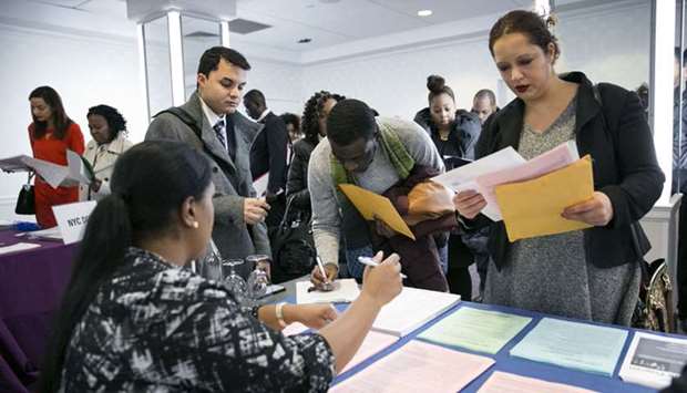 A New York Department of City Administrative Services representative (left), speaks with job seekers during a job fair in New York (file).