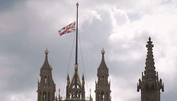 The Union Flag flies at half-mast from Victoria Tower over the Houses of Parliament in central London.