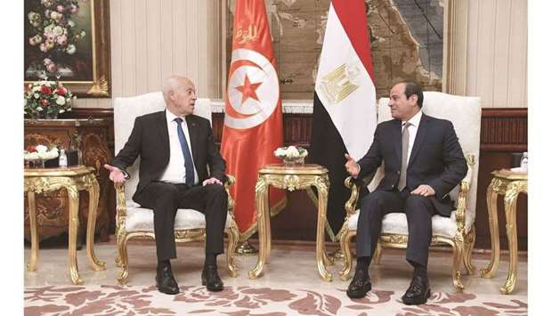 A handout picture provided by the Tunisian Presidency Facebook page yesterday shows Tunisian President Kais Saied meeting with Egyptian President Abdel Fattah al-Sisi in Cairo.