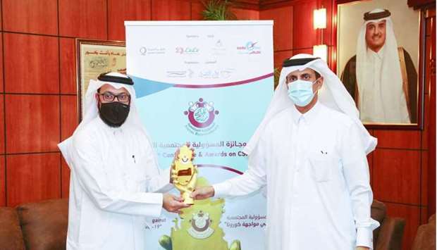HE Sheikh Dr Khalid bin Thani al-Thani, chairman of Dar Al Sharq, handing over the award to QC's Abdul Aziz Jassim Hajji.