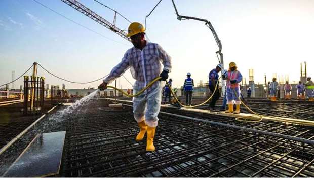Construction workers are seen at the Al Thumama Stadium