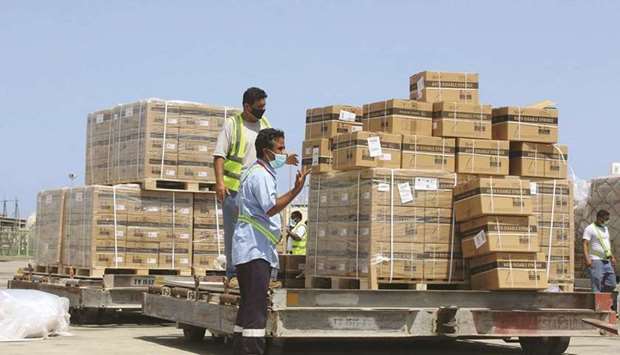 Employees transport boxes containing vials of the AstraZeneca/Covidshield vaccine against the coronavirus, upon their arrival at the airport of Yemenu2019s southern port city of Aden, yesterday.