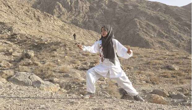 Martial arts student Fatima Batool of the Hazara community practises Shaolin Kung Fu during a self-defence martial arts training class on a mountain on the outskirts of Quetta. (AFP)
