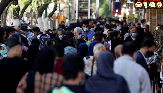 FILE PHOTO: Iranians wearing protective face masks against the coronavirus walk in a crowded area of the capital Tehran, Iran, March 30, 2021. (REUTERS)