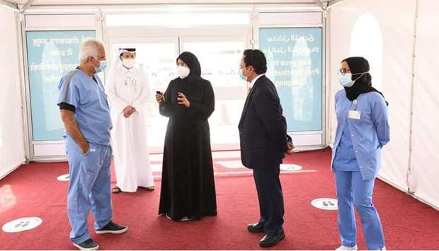 HE Dr. Hanan Mohamed Al Kuwari, Minister of Public Health, holds discussions with officials during the visit to the the new Covid-19 vaccination center in the Doha Industrial Area