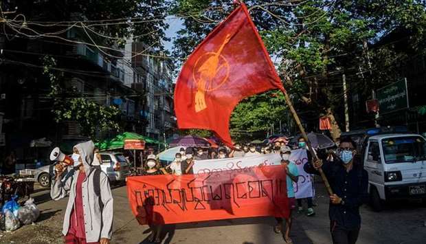 Protesters march during a demonstration against the military coup in Yangon on 11 April, 2021. (AFP)