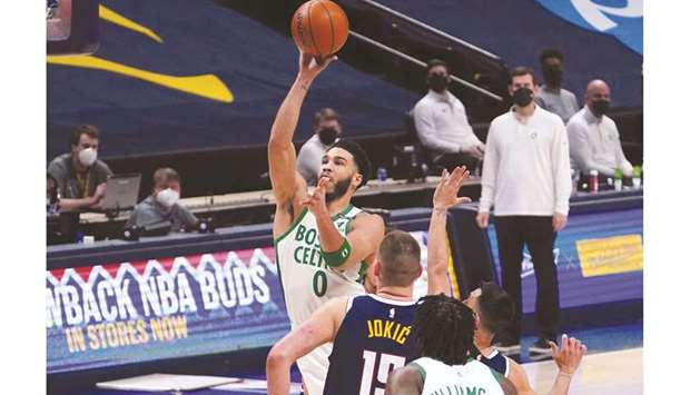 Boston Celtics forward Jayson Tatum shoots the ball over Denver Nuggets center Nikola Jokic in the first quarter at Ball Arena in Denver. (USA TODAY Sports)