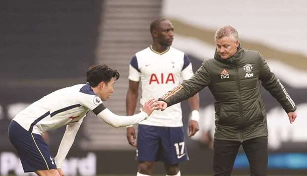 Manchester Unitedu2019s manager Ole Gunnar Solskjaer (right) bumps his fist with Tottenhamu2019s striker Son Heung-Min after the Premier League match on Sunday. (AFP)