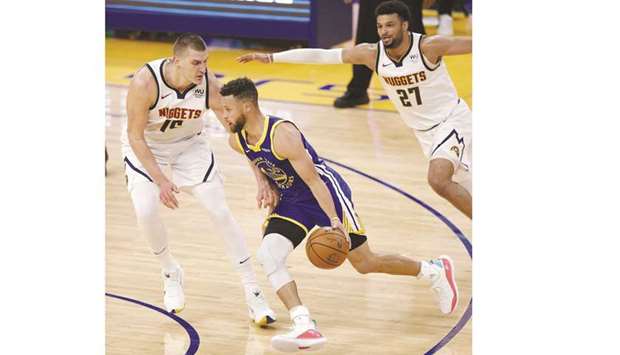 Stephen Curry of the Golden State Warriors is guarded by Nikola Jokic and Jamal Murray (right) of the Denver Nuggets at Chase Center in San Francisco. (Getty Images/AFP)