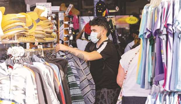 A customer wearing a protective mask shops at a store on Santa Monica Pier in Los Angeles. US consumer prices climbed in March by the most in nearly nine years as the end of pandemic lockdowns triggered a rebound in travel and commuting that pushed up the cost of gasoline, car rentals and hotel stays.