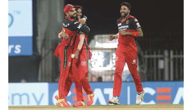 Royal Challengers Bangaloreu2019s Shahbaz Ahmed (centre) celebrates with captain Virat Kohli (left) and Mohamed Siraj after taking a Sunrisers Hyderabad wicket. (Sportzpics for IPL)