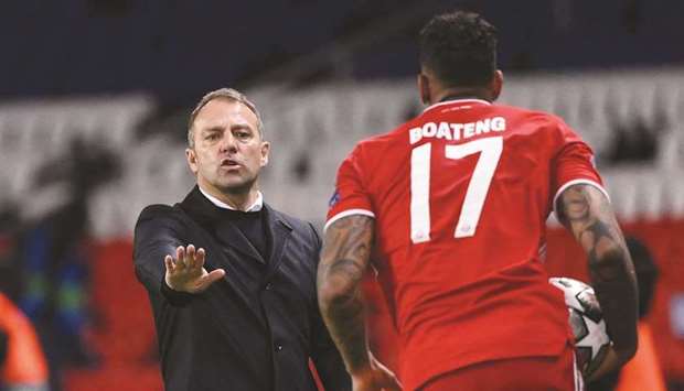 Bayern Munichu2019s German head coach Hans-Dieter Flick (left) gives instructions to defender Jerome Boateng during the Champions League quarter-final second leg against PSG. b(AFP)
