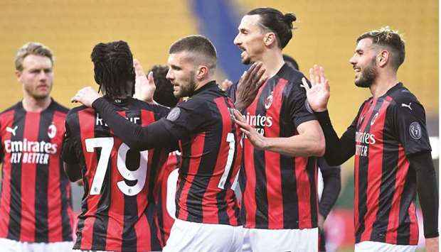 AC Milan players celebrate a goal during the Serie A match against Parma in Parma, Italy, on Saturday. AC Milan are second in the standings, and only four points separate them and fifth-placed Napoli. (Reuters)