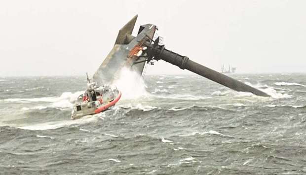 A Coast Guard Station Grand Isle boat heads toward a capsized commercial lift boat while searching for people in the water, eight miles (about 13km) south of Grand Isle, Louisiana.