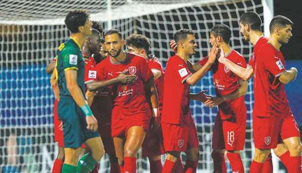 Al Duhail players (in red) celebrate their win over Al Shorta on Thursday.