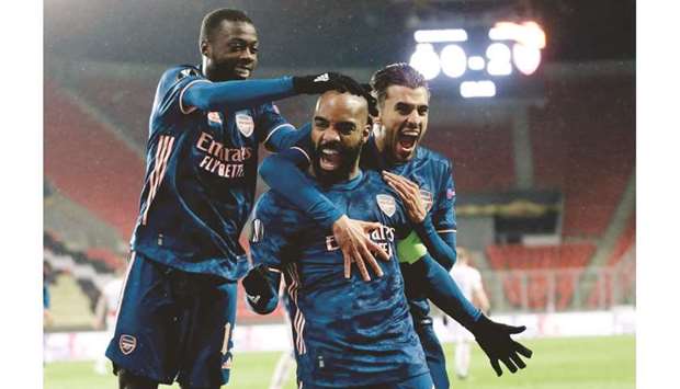 Arsenalu2019s Alexandre Lacazette (centre) celebrates with teammates after scoring against Slavia Prague during the Europa League quarter-final in Prague. (Reuters)