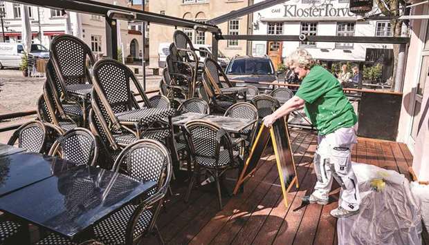 Chairs and tables are made ready for outdoor dining at CW Obels Plads in Aalborg, Denmark, yesterday, amid the novel coronavirus Covid-19 pandemic.