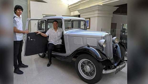 Galle Face Hotel chairman Sanjeev Gardiner (right) and his son Seshaan pose with the 1935 Standard Nine vintage car which is claimed to be owned and the first car of Prince Philip  now acquired by the Gardiner family in Colombo recently. (AFP)