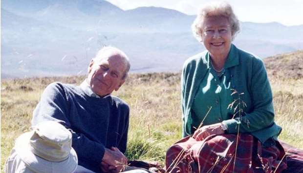Britain's Queen Elizabeth II and her husband Britain's Prince Philip, the Duke of Edinburgh, at the top of the Coyles of Muick near Ballater in the Cairngorms National Park in Scotland in 2003. Photo by The Countess of Wessex/BUCKINGHAM PALACE/AFP