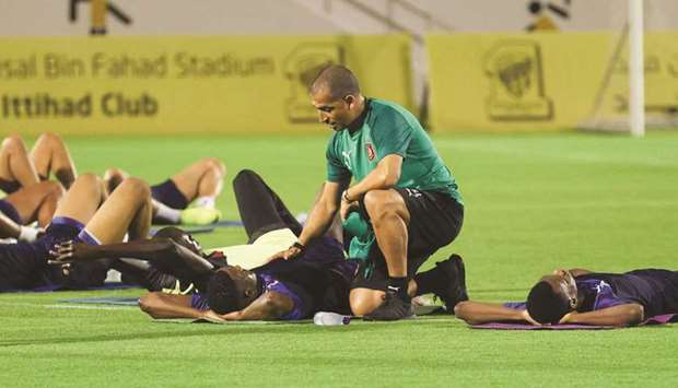 Al Duhail head coach Sabri Lamouchi checks on a player during training session in Jeddah