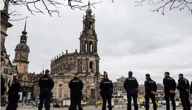 Police officers secure an area in front of the Cathedral in the city center in Dresden, eastern Germany yesterday amid the coronavirus pandemic