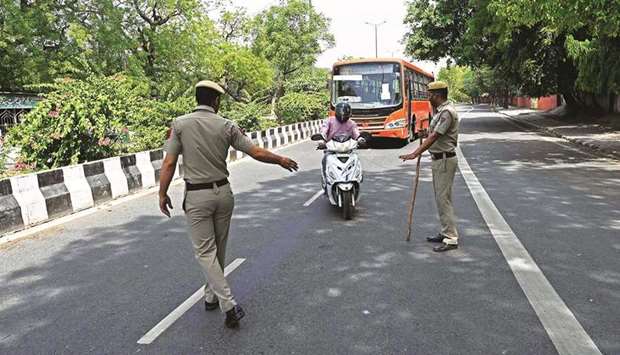 Police stop vehicles to check the identification papers of the commuters as a weekend lockdown is in effect wherein only people catering to essential services were allowed to commute as directed by the Delhi state government to curb the spread of Covid-19 infections in New Delhi, yesterday.