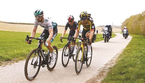 From left: Max Schachmann (Bora-Hansgrohe), Tom Pidcock (Ineos Grenadiers) and Wout van Aert (Jumbo-Visma) compete in the Amstel Gold Race in Valkenburg yesterday. (AFP)
