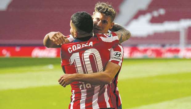 Atletico Madridu2019s Marcos Llorente (right) celebrates with Angel Correa after scoring a goal during the La Liga match against Eibar in Madrid yesterday. (AFP)