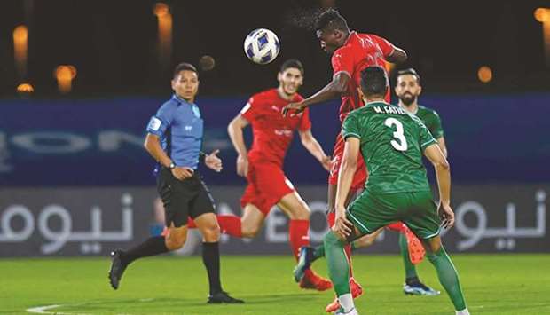Al Duhailu2019s Michael Olunga heads the ball during their match against Al Ahli in Jeddah Sunday.
