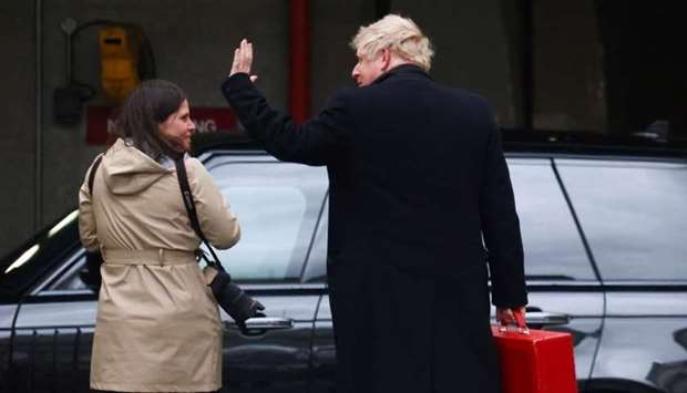 Britain's Prime Minister Boris Johnson waves as he arrives in Wellington Barracks in London, Britain on April 15