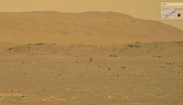 NASA's Mars helicopter Ingenuity makes its first flight on the planet in this still image taken from