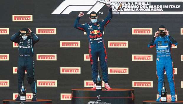 Red Bullu2019s Max Verstappen (C) celebrates after finishing first on the podium, with second placed Lewis Hamilton of Mercedes and third placed,Lando Norris of McLaren.