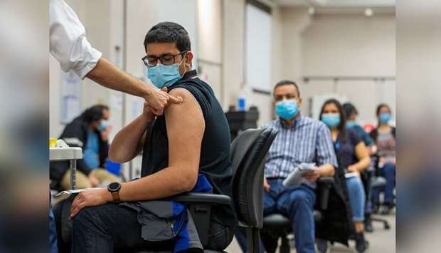 (File photo) A young man get Covid vaccination in Ontario, Canada. (Reuters)