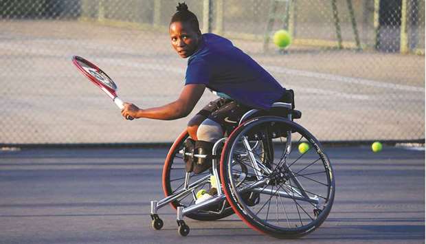 South Africau2019s wheelchair tennis player Kgothatso Montjane plays a backhand shot during a training session at the High Performance Centre in Pretoria on April 13, 2021. (AFP)