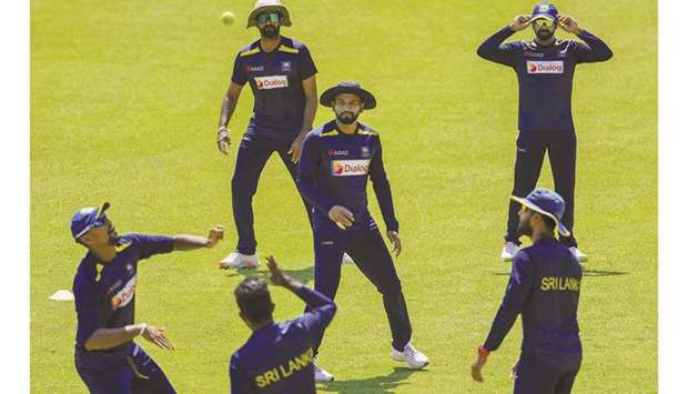 Sri Lankan players warm up during a practice session ahead of their first Test match against Bangladesh at the Pallekele International Cricket Stadium in Kandy yesterday. (AFP)