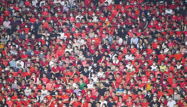Fans watch the Chinese Super League match between Guangzhou FC and Guangzhou City in Chinau2019s southern Guandong province yesterday. (AFP)