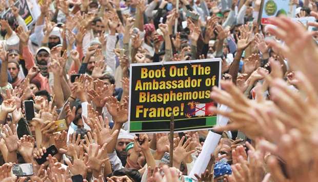 DEMAND: Supporters of the banned Tehrik-e-Labaik Pakistan (TLP) chanting slogans as they carry a sign during a protest in Lahore yesterday. (Reuters)