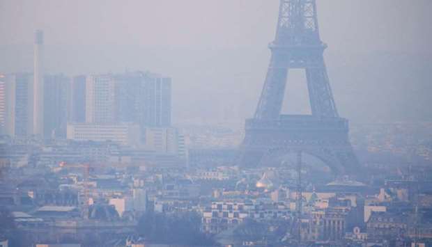 (file photo) The Eiffel Tower is surrounded by a small-particle haze which hangs above the skyline in Paris