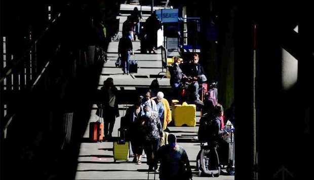 Travellers walk through a pick-up area in the arrivals section at Seattle-Tacoma International Airport in SeaTac, Washington, US recently. REUTERS