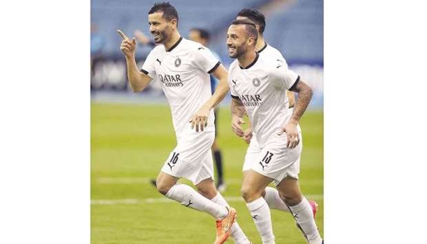 Al Sadd players Boulem Khoukhi (left) and Guilherme celebrate a goal in their 3-1 victory over Al Wehdat in their AFC Champions League Group D match on Tuesday.