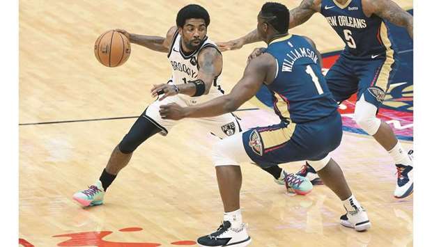 Kyrie Irving (left) of the Brooklyn Nets drives against Zion Williamson of the New Orleans Pelicans during the first half at the Smoothie King Center in New Orleans, Louisiana. (Getty Images/AFP)