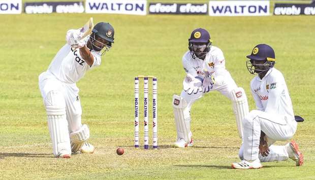 Bangladeshu2019s Najmul Hossain Shanto (left) plays a cover drive during the first day of the first Test against Sri Lanka at the Pallekele International Cricket Stadium in Kandy yesterday. (AFP)