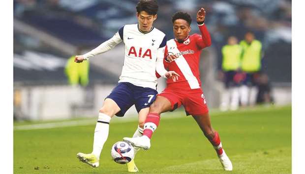 Southamptonu2019s Kyle Walker-Peters (right) vies for the ball with Tottenham Hotspuru2019s Son Heung-Min during the English Premier League match at Tottenham Hotspur Stadium in London yesterday. (AFP)