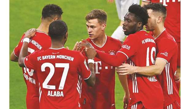 Bayern Munichu2019s Joshua Kimmich (centre) celebrates with teammates after scoring against Bayer Leverkusen in the Bundesliga in Munich on Tuesday. (AFP)