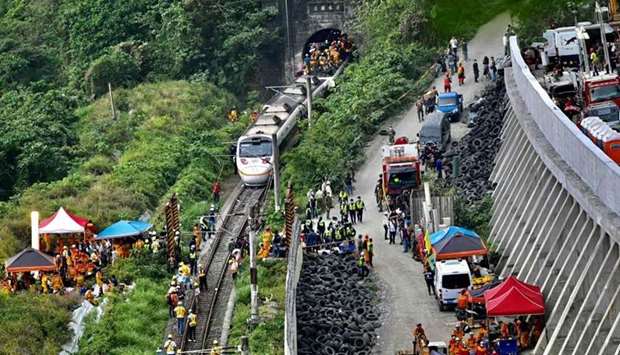 Rescue workers at the site where a train derailed inside a tunnel in the mountains of Hualien, eastern Taiwan.Sam Yeh/AFP