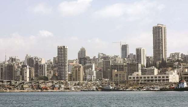 Damaged residential buildings stand beyond destroyed warehouses at the Port of Beirut. According to two diplomatic sources with knowledge of the plans, Germany and France are vying to lead reconstruction efforts in Lebanon.