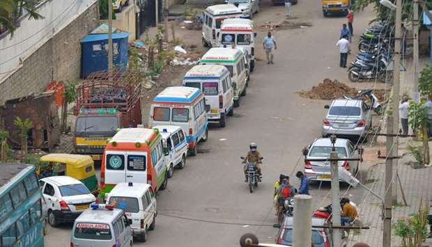 Ambulances carrying the dead victims of Covid-19 coronavirus disease line outside a municipal crematorium in Bangalore, India