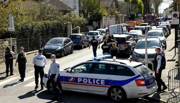 French police officials block off a street near a police station in Rambouillet, south-west of Paris, after a female police administrative worker was stabbed to death in the town