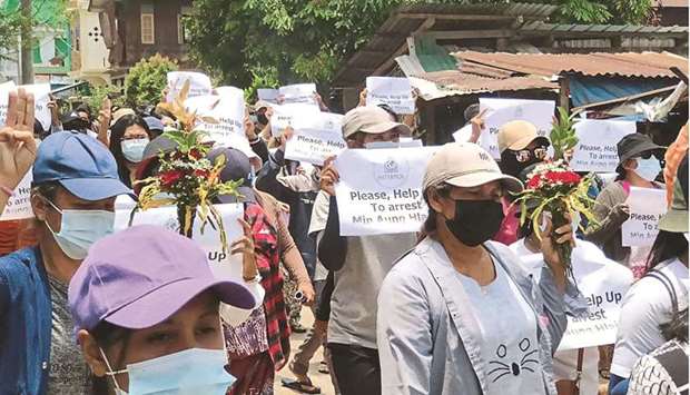 This handout photo taken and released by Dawei Watch yesterday shows protesters holding signs calling for the arrest of Myanmar armed forces chief Senior General Min Aung Hlaing during a demonstration against the military coup in Dawei.